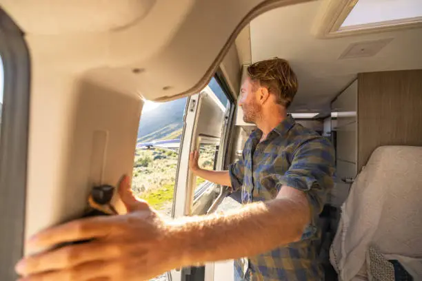 People travel, alternative homes concept. He looks at the beauty in nature. Sunset time on top of mountain pass
